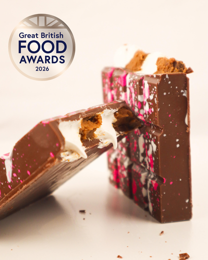 Close up of broken S’mores stuffed bar with marshmallow fluff, Biscoff filling and Great British Food Awards 2026 Bronze badge