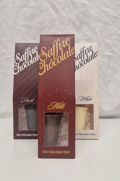 Three boxes of Milly Superfine Chocolate from Milly Chocolates, showing different chocolate fillings (Meringue, Cream, and Dark), arranged on a white textured fabric background.