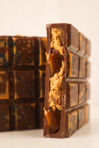 Close-up of a chocolate bar with a visible filling on a white background